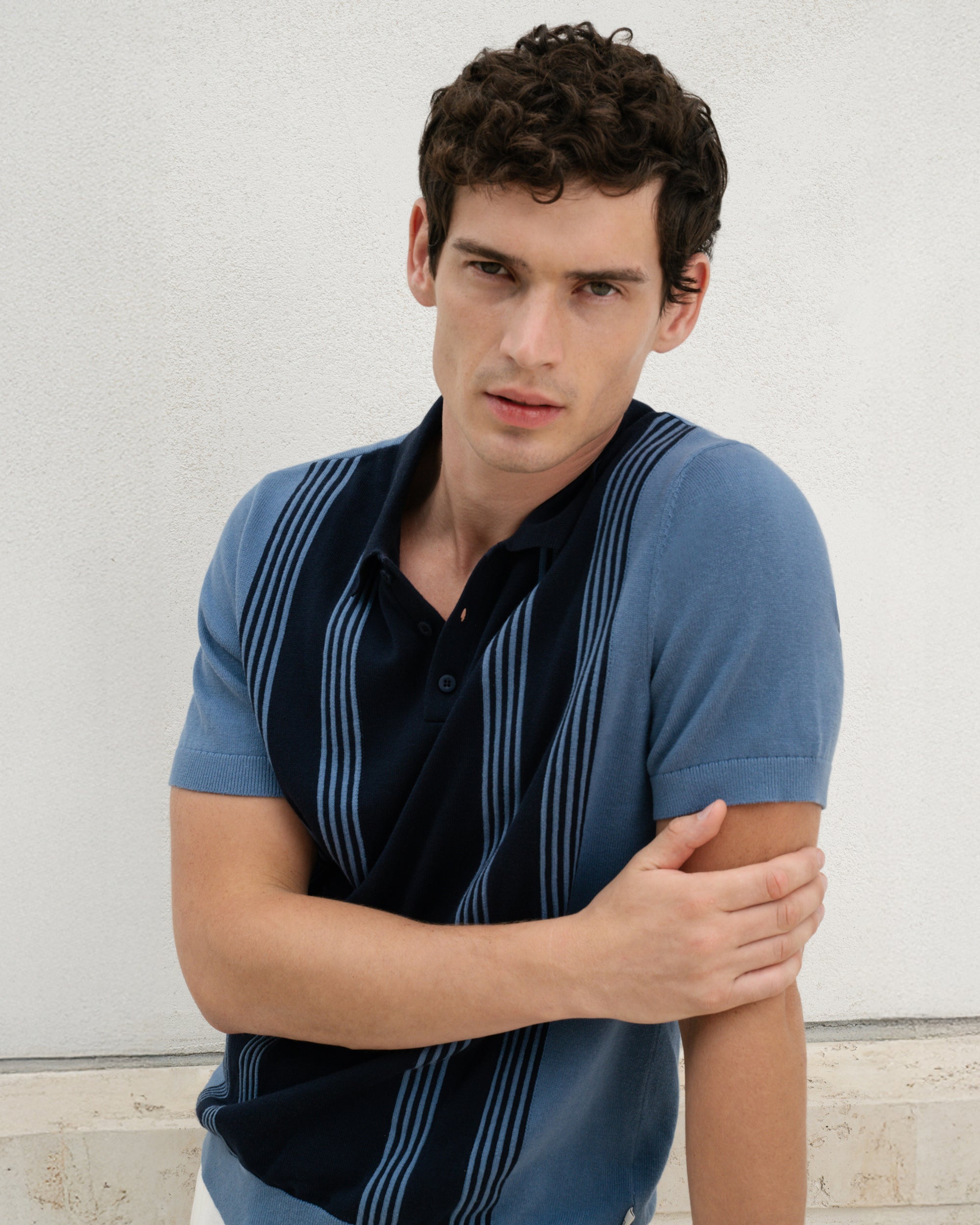 Man wearing a blue striped shirt against a light background